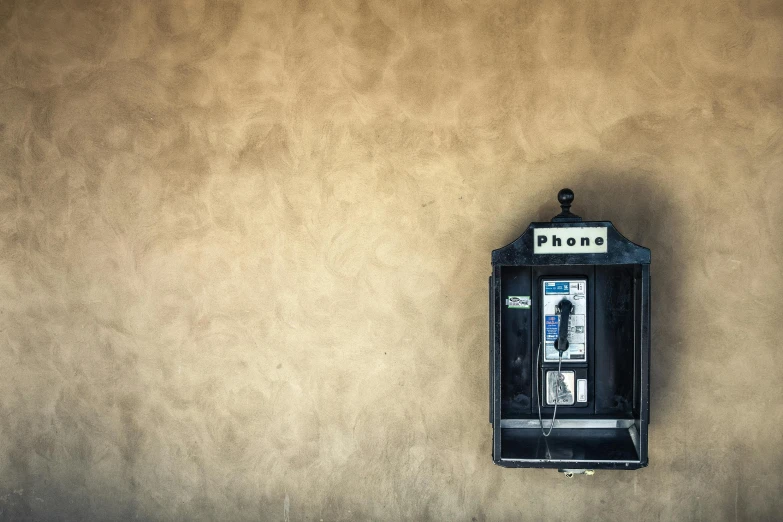 a phone on a wall with a light switch on it