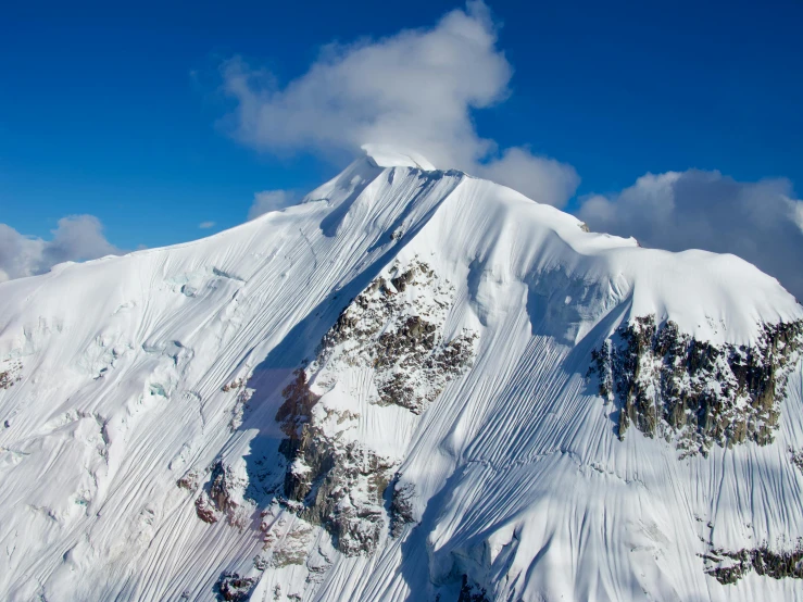 a snowy mountain top that has some snow on it