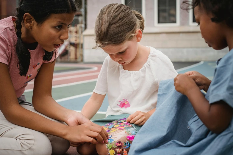 three young children sitting around each other in a circle