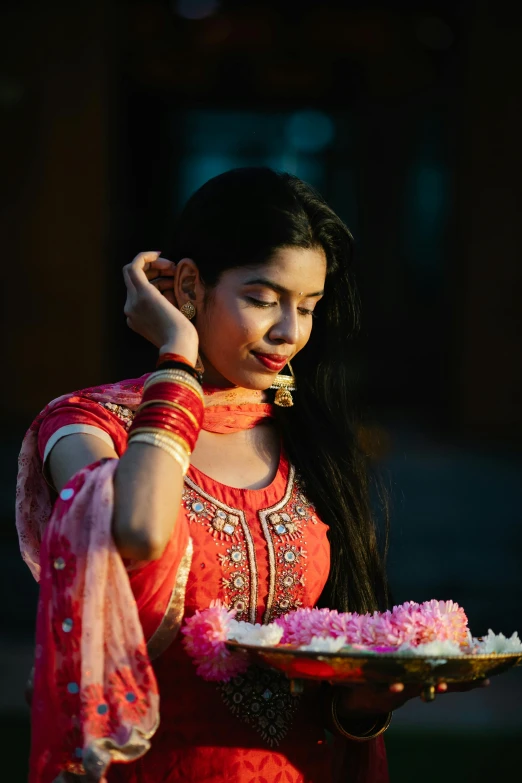 a woman holding a cake and talking on the phone