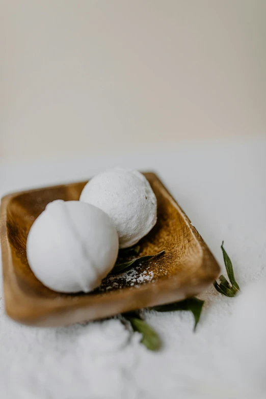 three white stuff sitting on top of a wooden  board