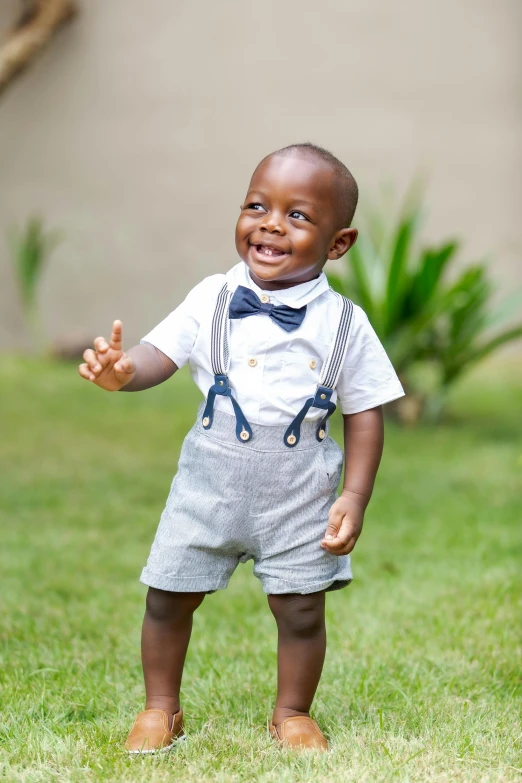 a small child is playing in the grass