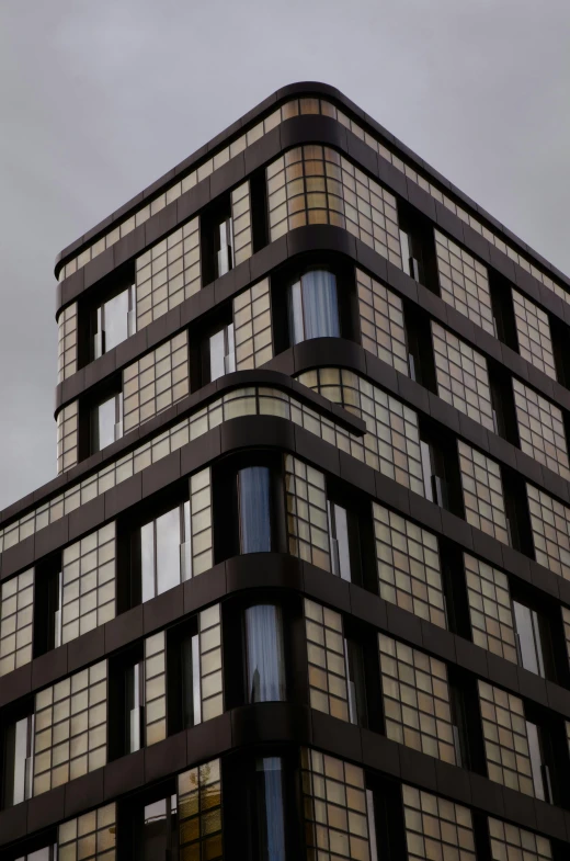 the top half of an office building, seen against the sky