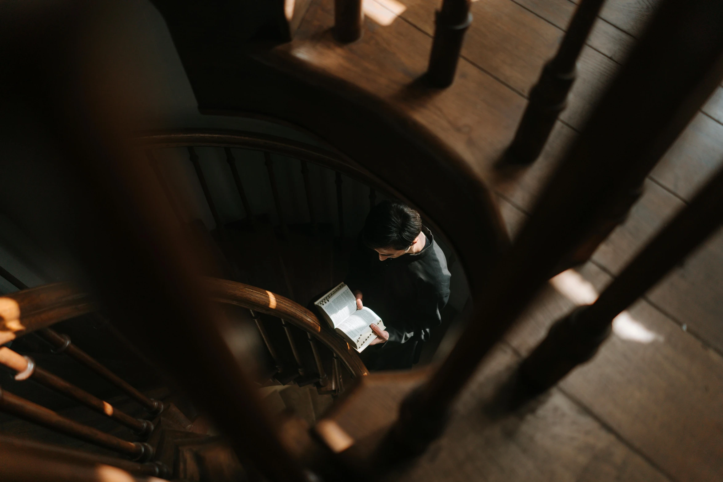 a woman standing by the steps in a building