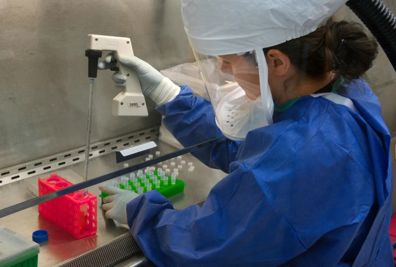 an experimenter injecting colored 3d models onto the assembly line