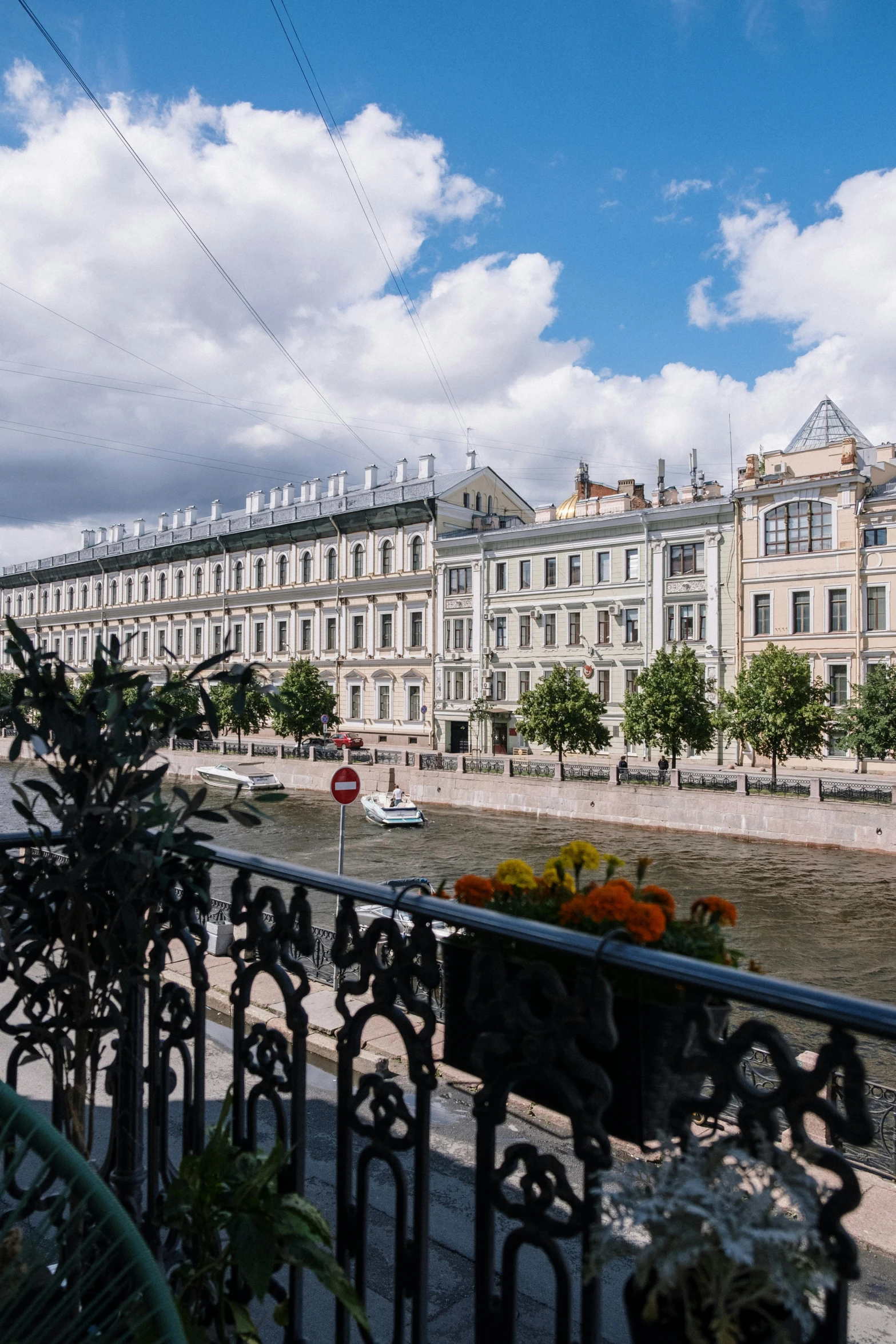 a balcony view with some flowers on the fence