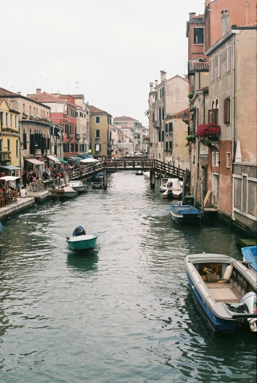 a river running through a small city next to tall buildings