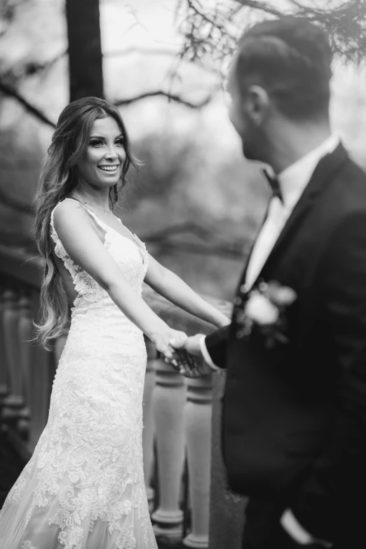 a couple holding hands during their wedding ceremony