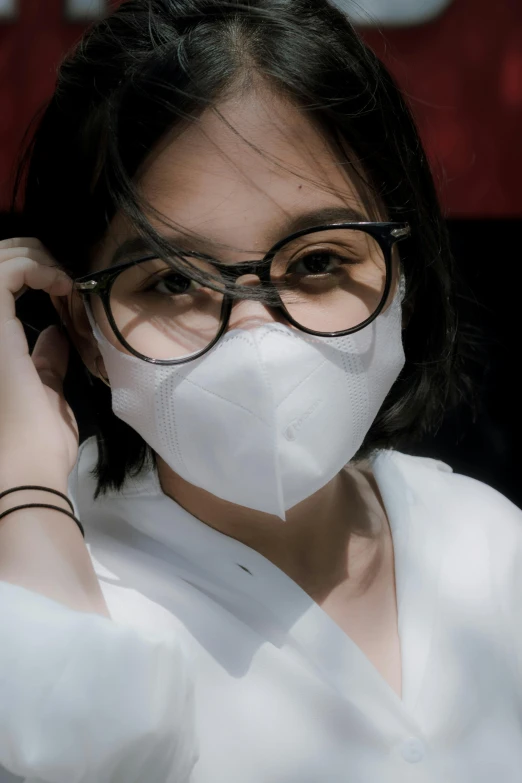 the girl is wearing glasses and a face mask