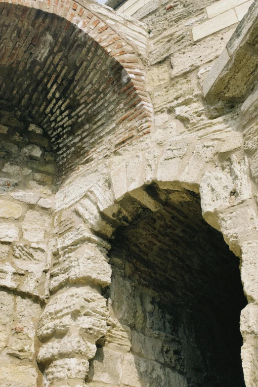 a brick building with a window at one end and a small wall at the other