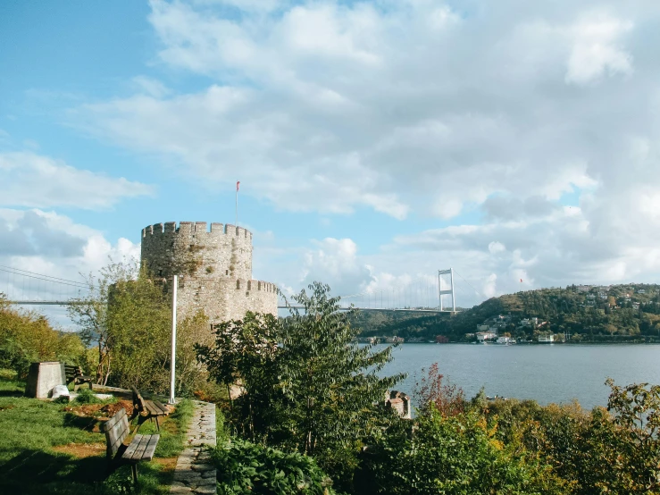 the stone bridge is in front of a tower