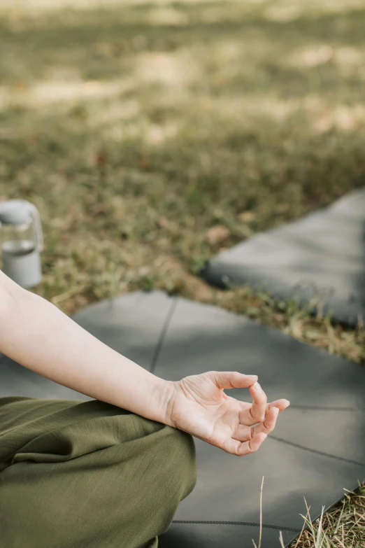 a man sitting on the ground doing yoga exercises