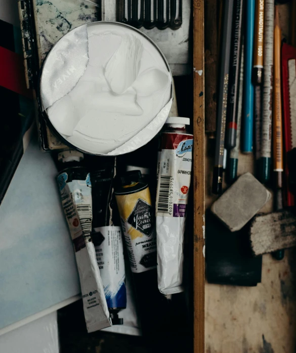 several art supplies sit inside of a drawer