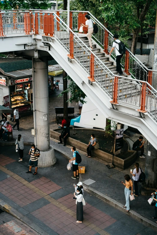 several people walking up and down some stairs