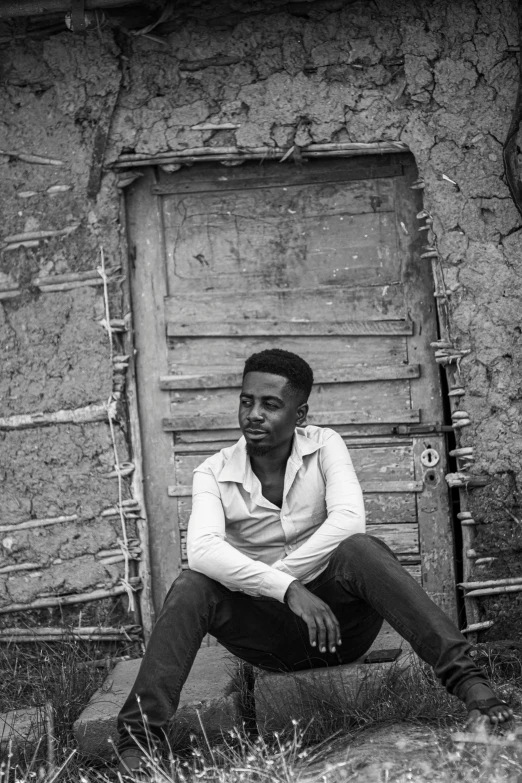 a man sitting outside of an old building