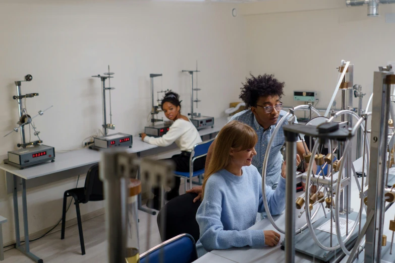 some people in an electrical lab sitting at their desks