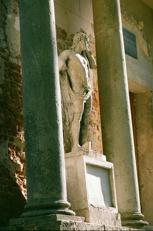 large stone statue sitting next to some stone pillars