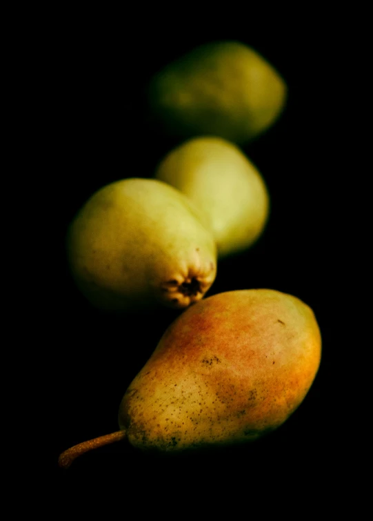 three pears sitting next to one another