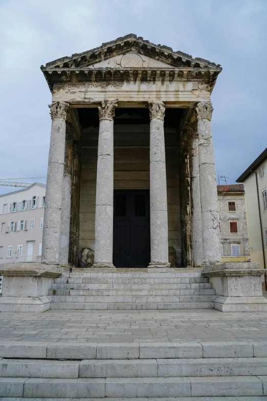 an image of a stairway with two columns and a door