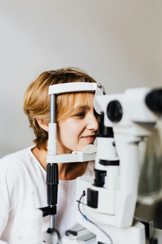 a woman looking at soing with an ophtromm