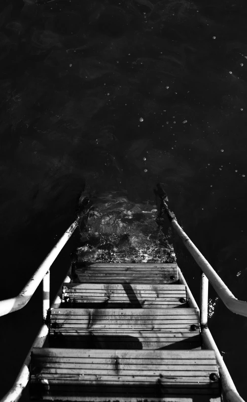 a dock with two long poles that have a water way above it