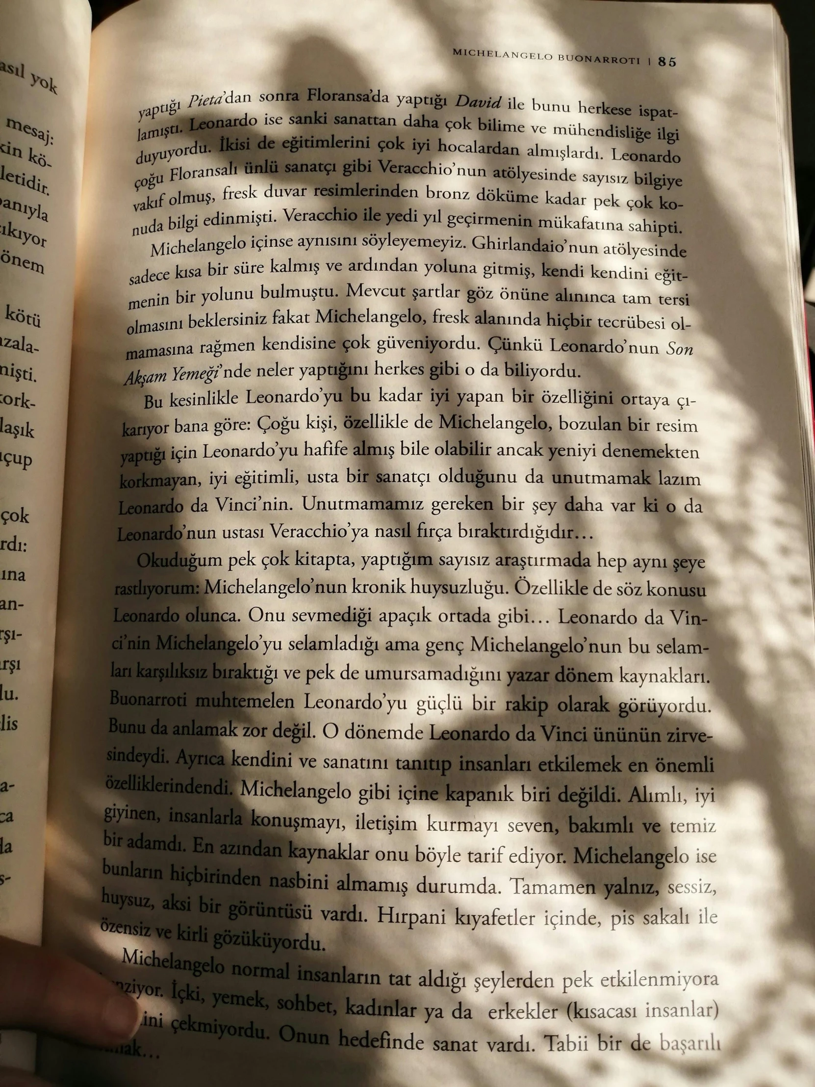 the shadow of a person behind an open book