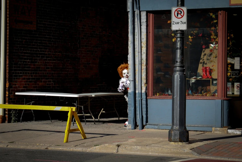 a yellow bench sits out side a building