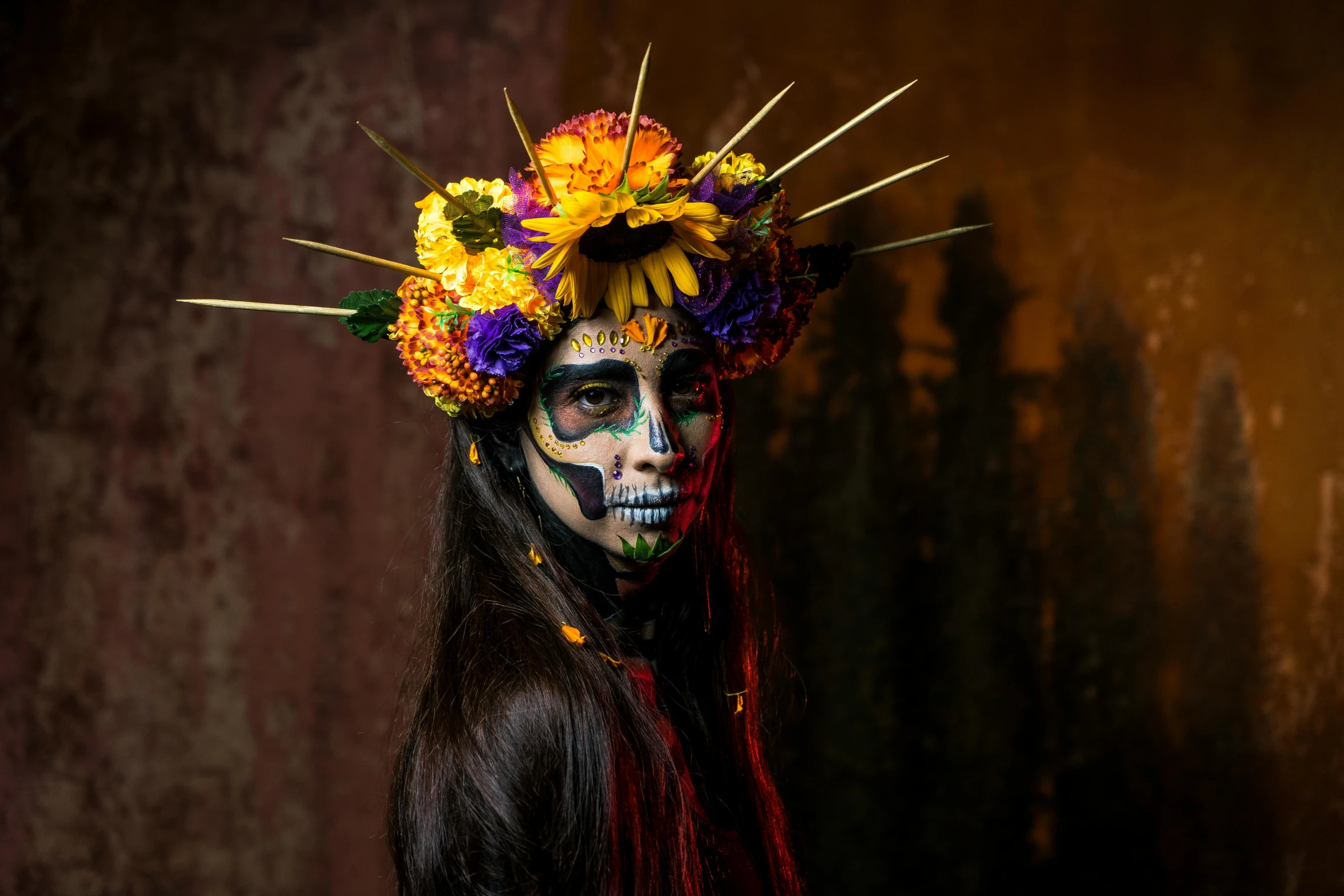 a woman with makeup and colorful flowers on her head