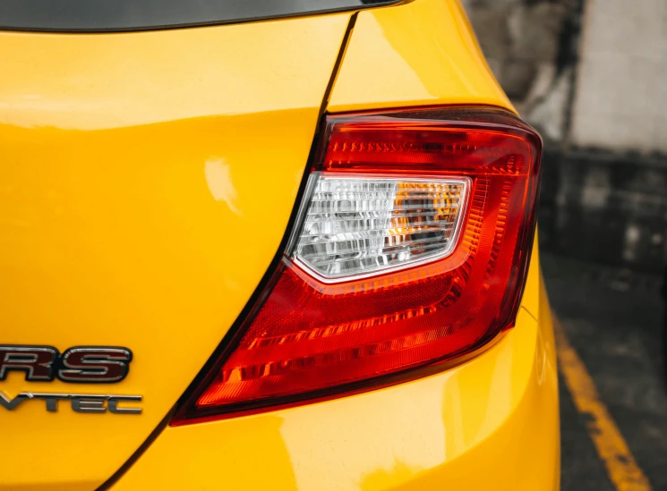 a yellow car parked in a parking lot