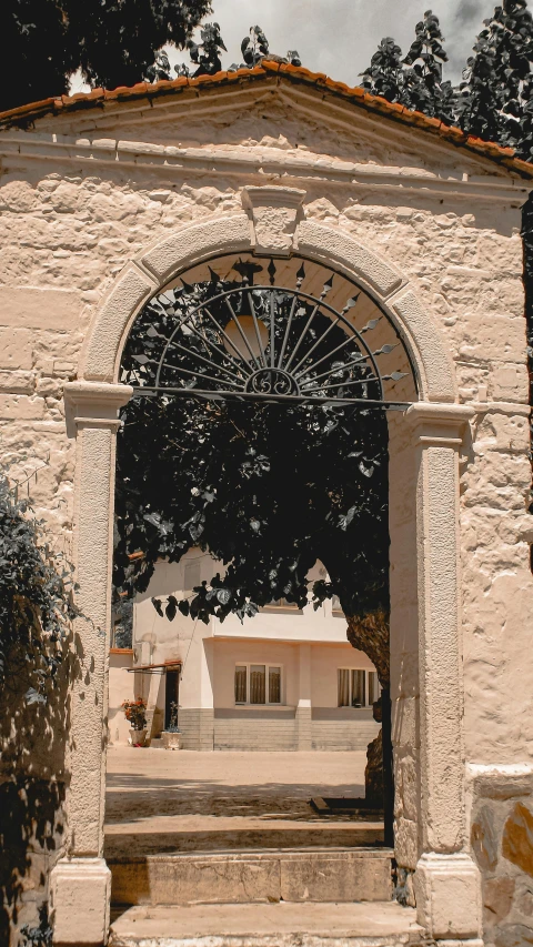 a courtyard with a sculpture under an archway