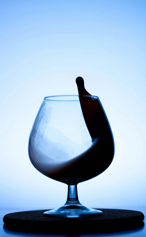 a glass full of liquid on top of a blue counter