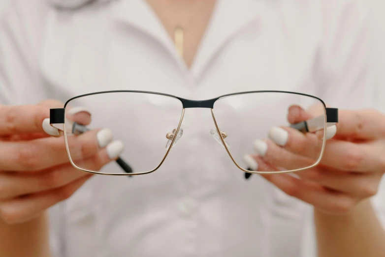 closeup of a person holding up some sunglasses