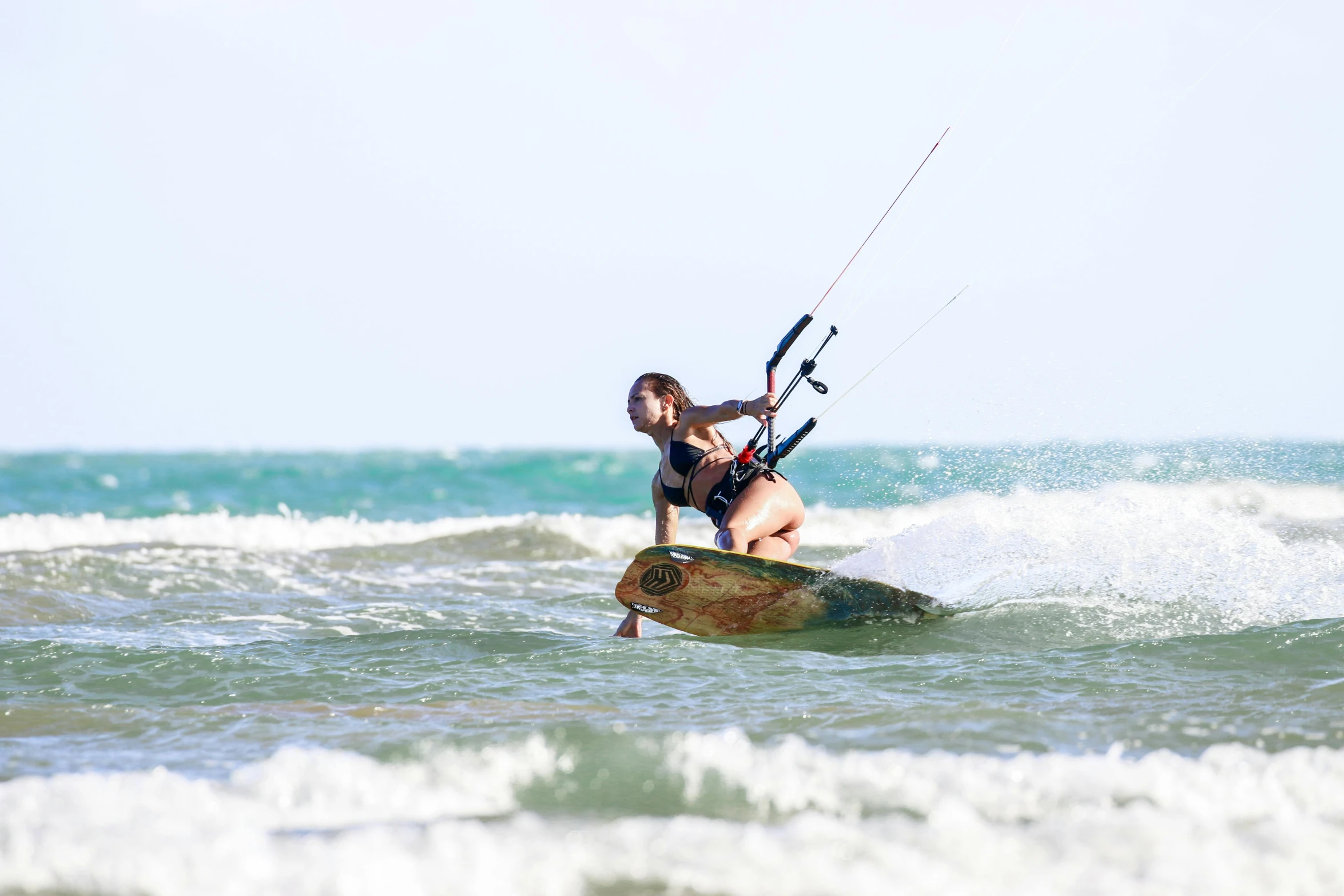 a woman riding a board in the ocean on a board