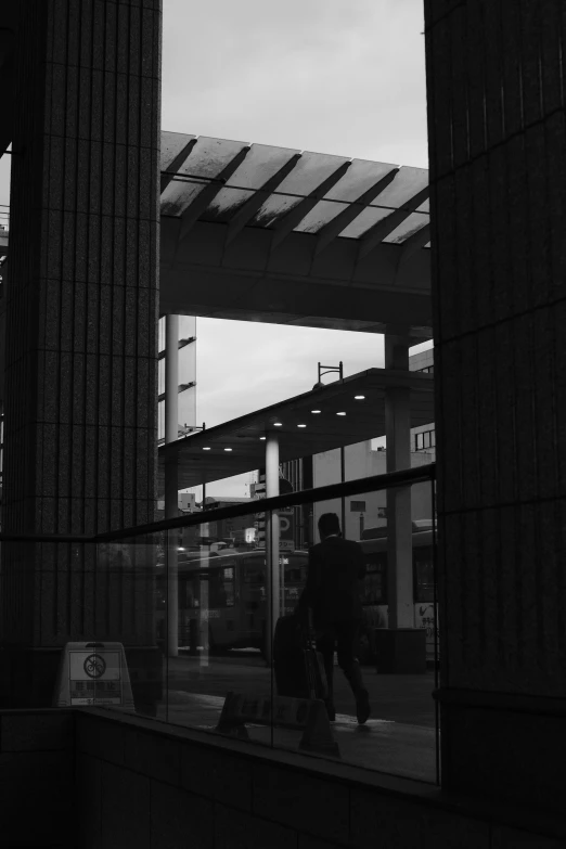 the reflection of people walking on a walkway in a window