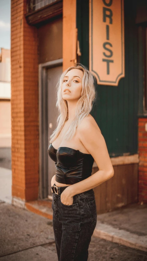 a young woman in black top posing for a po