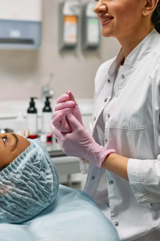 the dentist has placed her hand up to someone's head