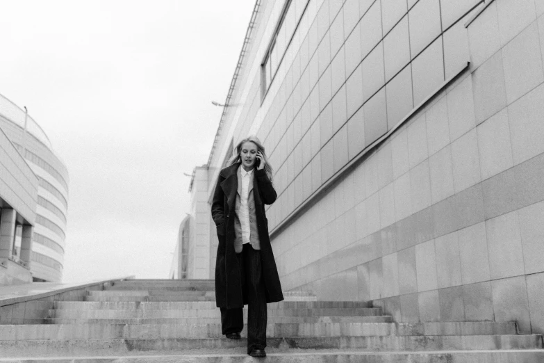 a black and white po of a woman walking down the steps