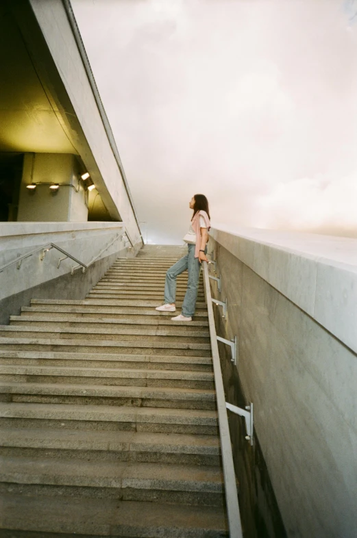 a woman standing at top of a set of steps