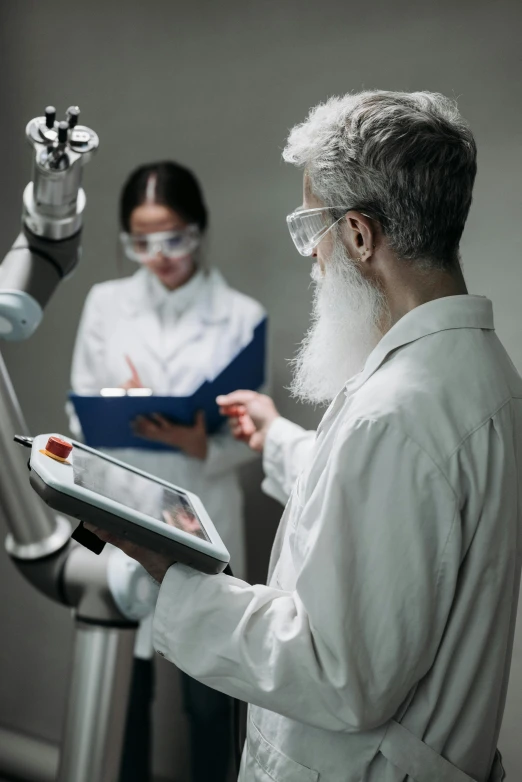 two people in science fiction costumes look at a tablet
