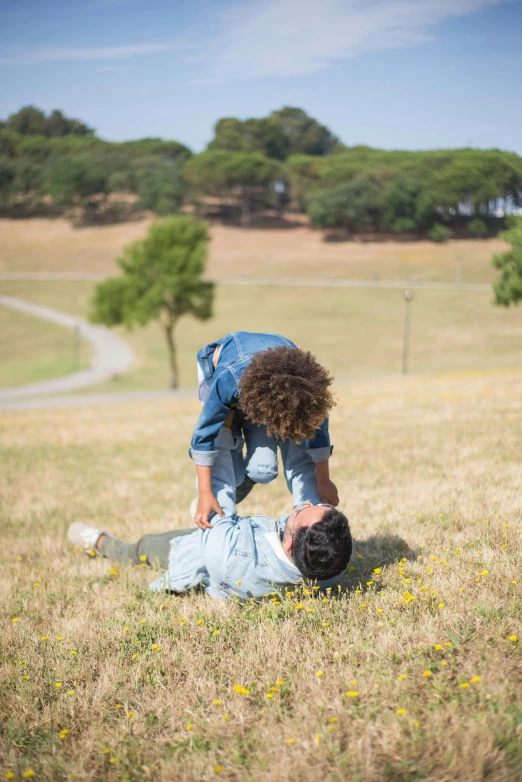 one person lying on the ground and another standing