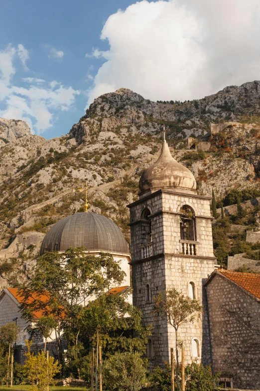 an old stone church with domed bell towers