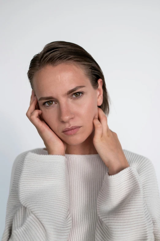 a woman posing in a sweater, posing for the camera