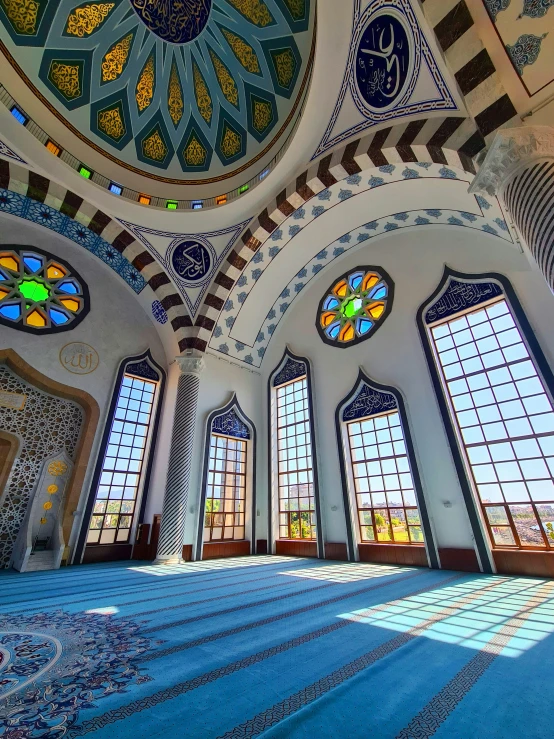 this picture is of a hall with beautiful glass windows