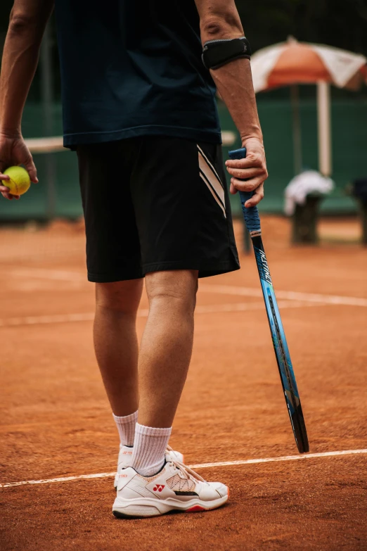 a tennis player with his foot on the court