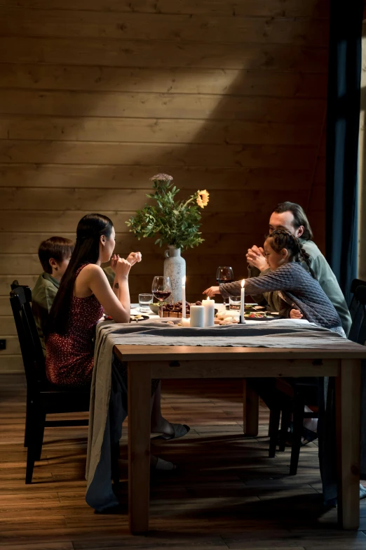 a couple of people sitting at a table with food