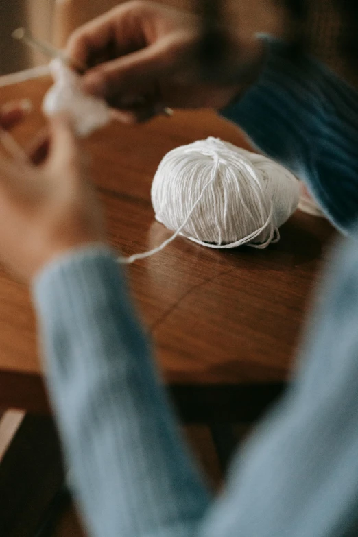 a person knitting soing on a table