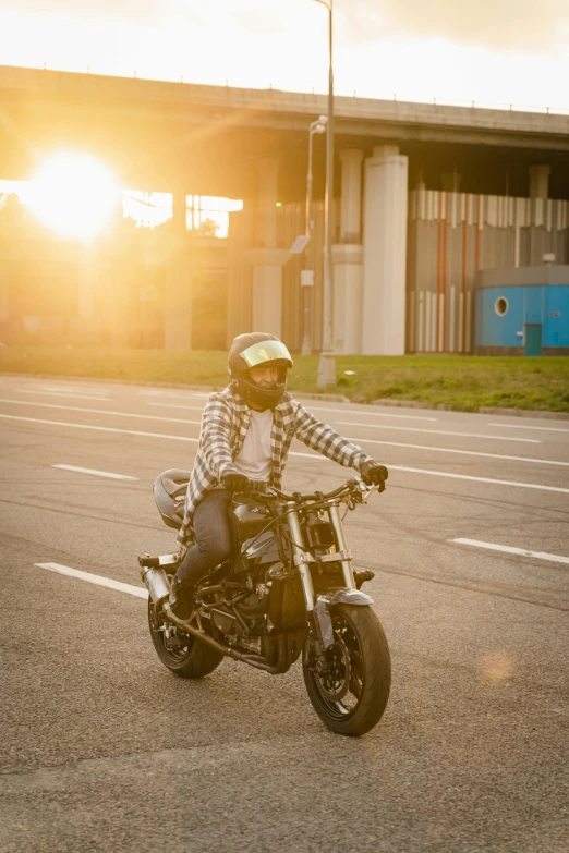 a person riding on a motorcycle in the middle of the road