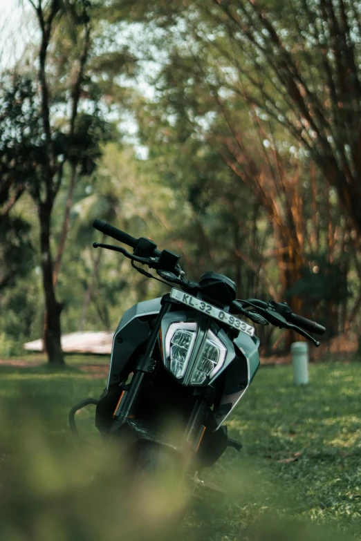 a parked motorcycle with its bike rack out in the field