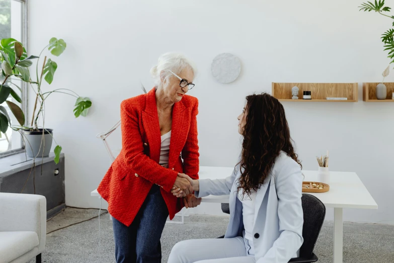 an old woman is talking to another lady about soing