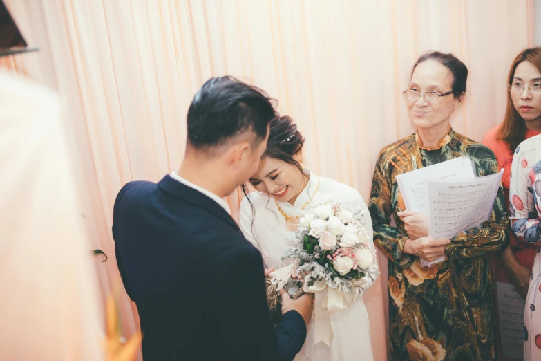 a couple getting married while others watch